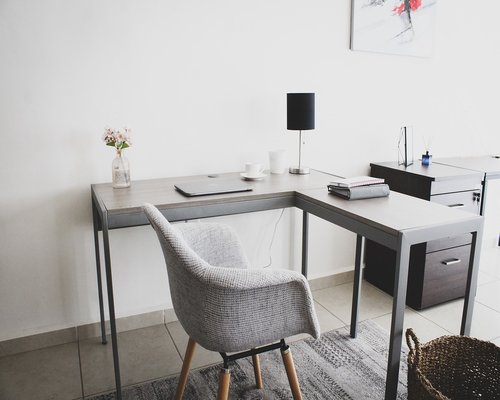 A light-filled home interior with an organized wooden desk and ergonomic considerations