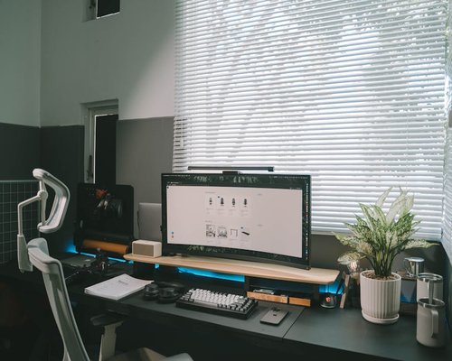 A tidy home office desk setup with natural light emphasizing ergonomics and comfort